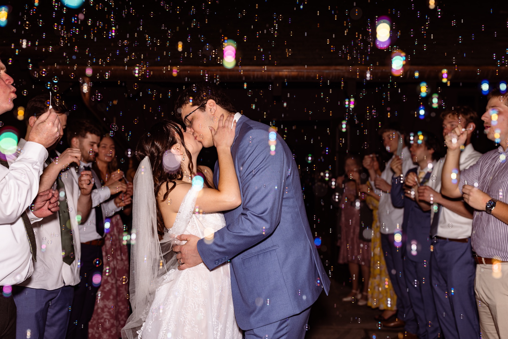 Wedding couple surrounded by bubbles